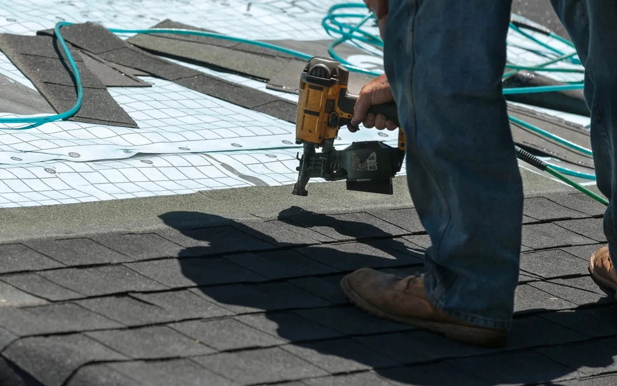 Synthetic underlayment covering the roof deck as new shingle courses are nailed down over it